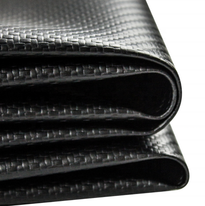 A close-up of a black carbon fiber textured material, showing a woven pattern and glossy finish, rolled over on a white background.